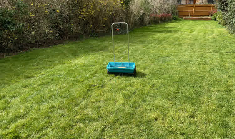 Drop spreader on a grass lawn.