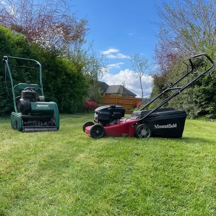 lawn mower and scarifier on a lawn.